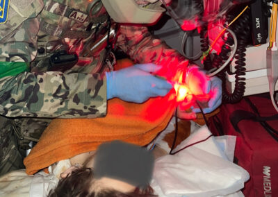 This little girl was critically wounded as she played at her home. She sustained 4 fractured limbs, a traumatic brain injury and 7 small shrapnel holes in her torso. 40 minutes into the critical transfer, she had a tension pneumothorax which we dealt with. She was vomiting constantly but we had no anti-emetics. A few minutes after this photo was taken (the windows are all blacked out), we were ambushed by mortars. We saved this child but could do nothing for her 12 year old sister. her two little playmates also died at scene.